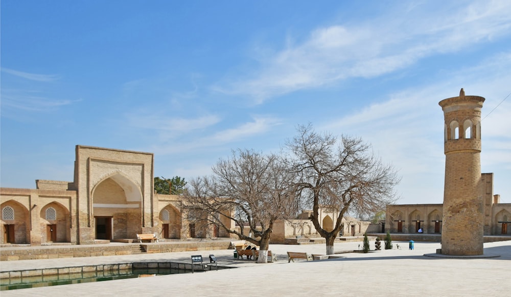 the courtyard of a building with a clock tower in the background