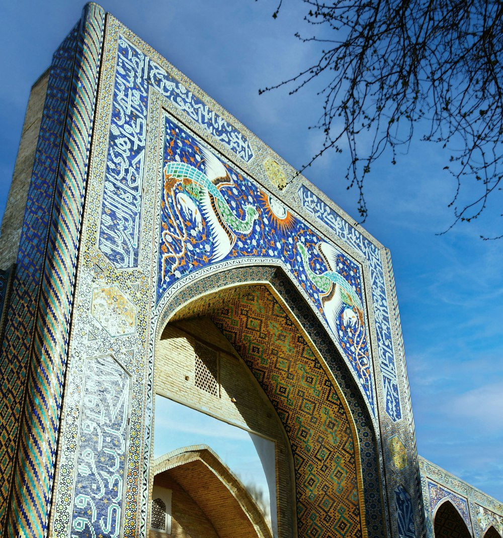 an ornate archway with a blue sky in the background