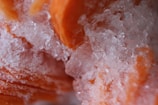 Close-up of frozen paneer masala gravy in a clear container with frost on the surface