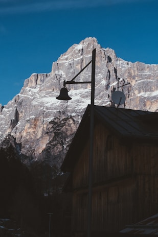 A remote mountain lodge with Star Wifi CA satellite equipment visible on the roof, overlooking a vast wilderness.