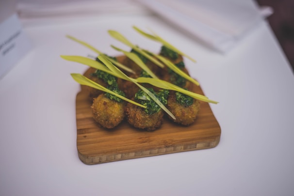 Crispy bacon wrapped rice balls served with a side of pickled radishes and lime.