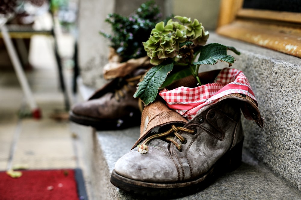 a pair of shoes sitting on the side of a building