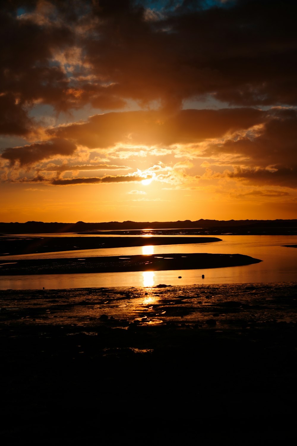 the sun is setting over a body of water