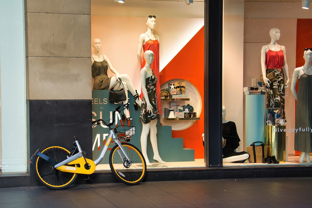 a bicycle parked in front of a store window