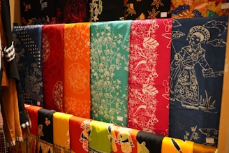 a row of colorful towels hanging on a wall