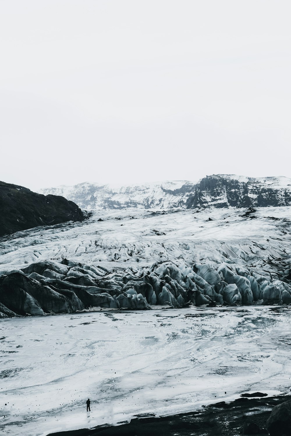 a person standing in the middle of a glacier