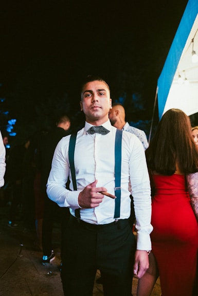 a man in a white shirt and black bow tie