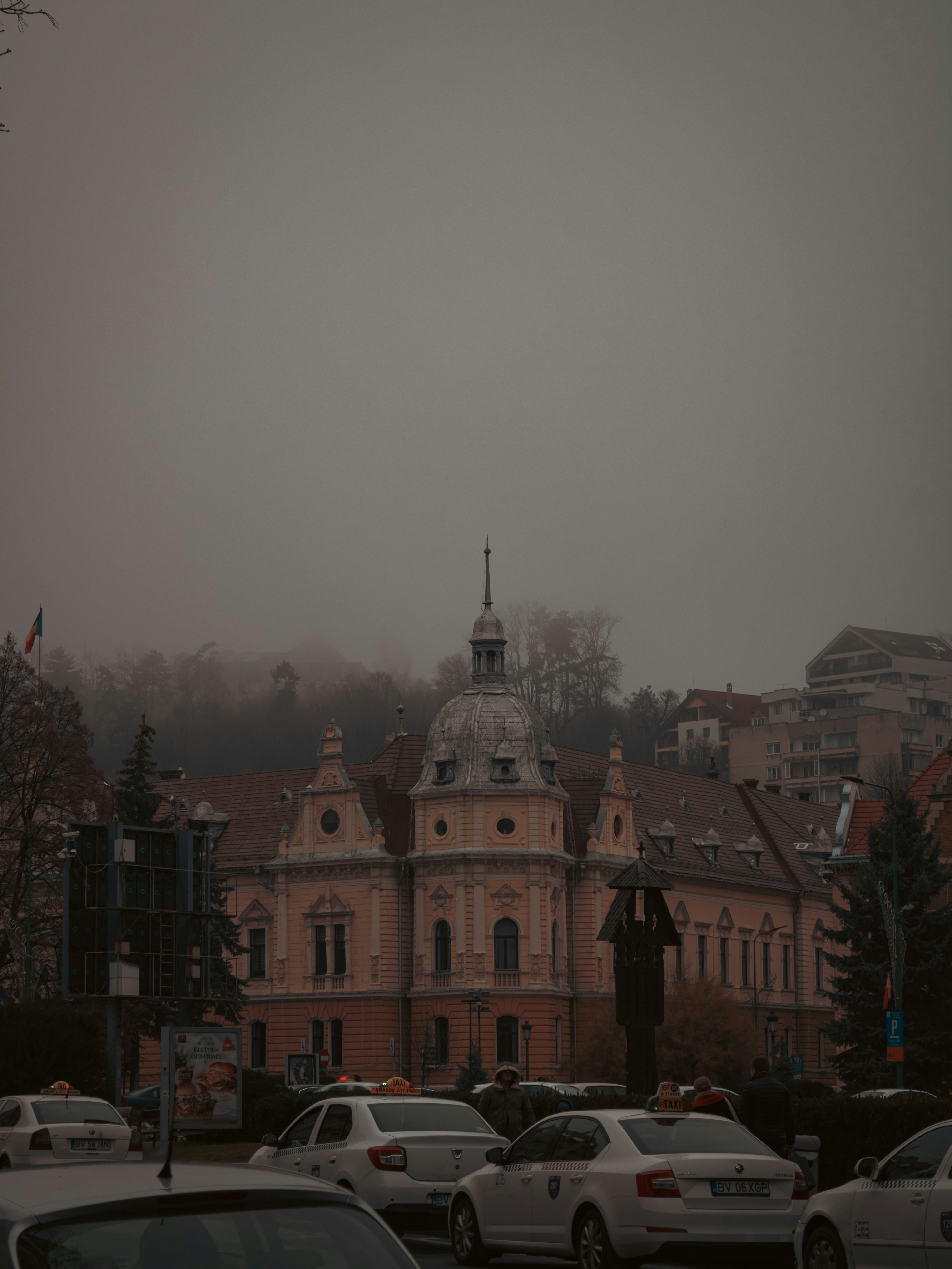 cars parked in a parking lot in front of a building