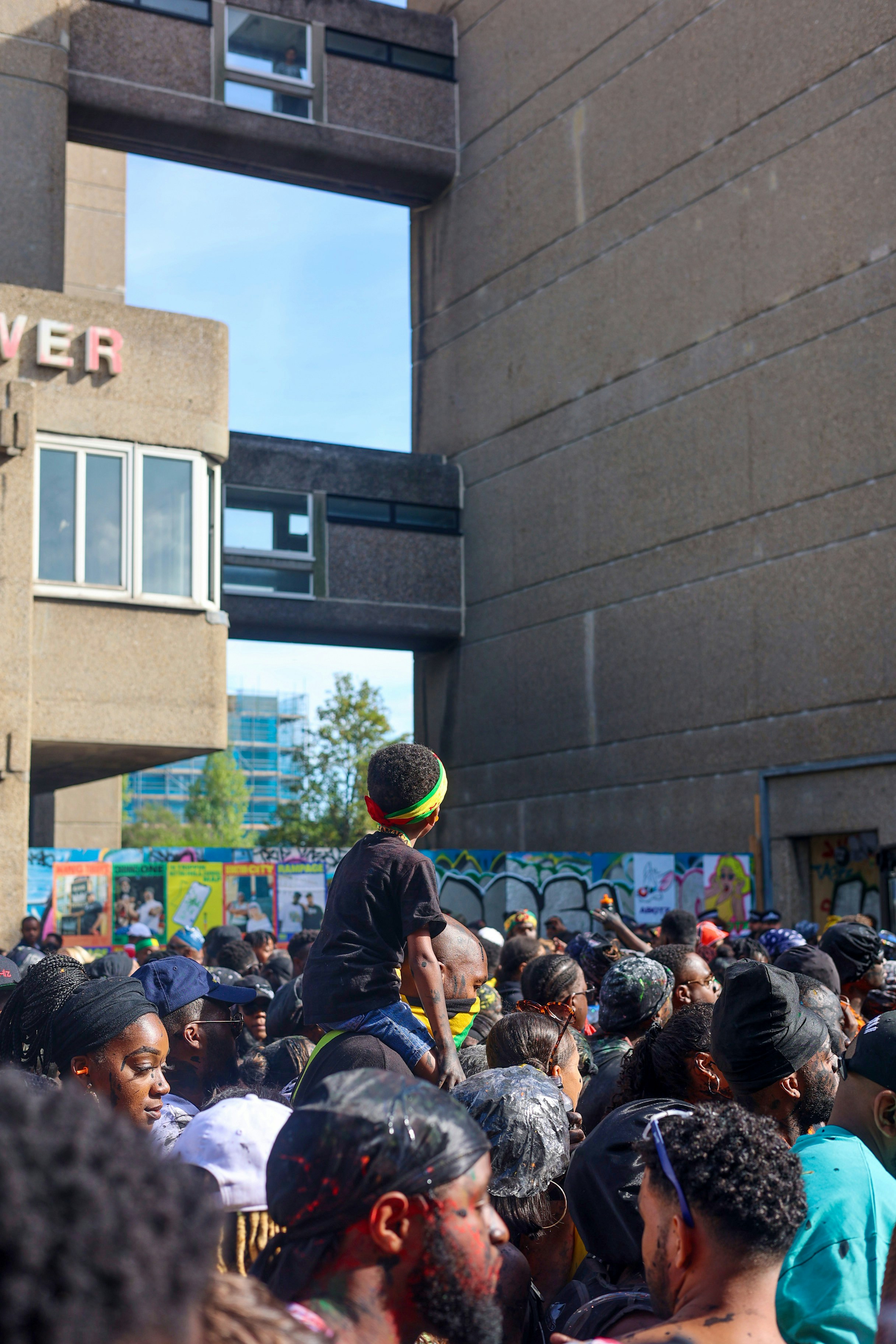 a crowd of people standing in front of a building