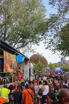 a crowd of people standing around a food truck
