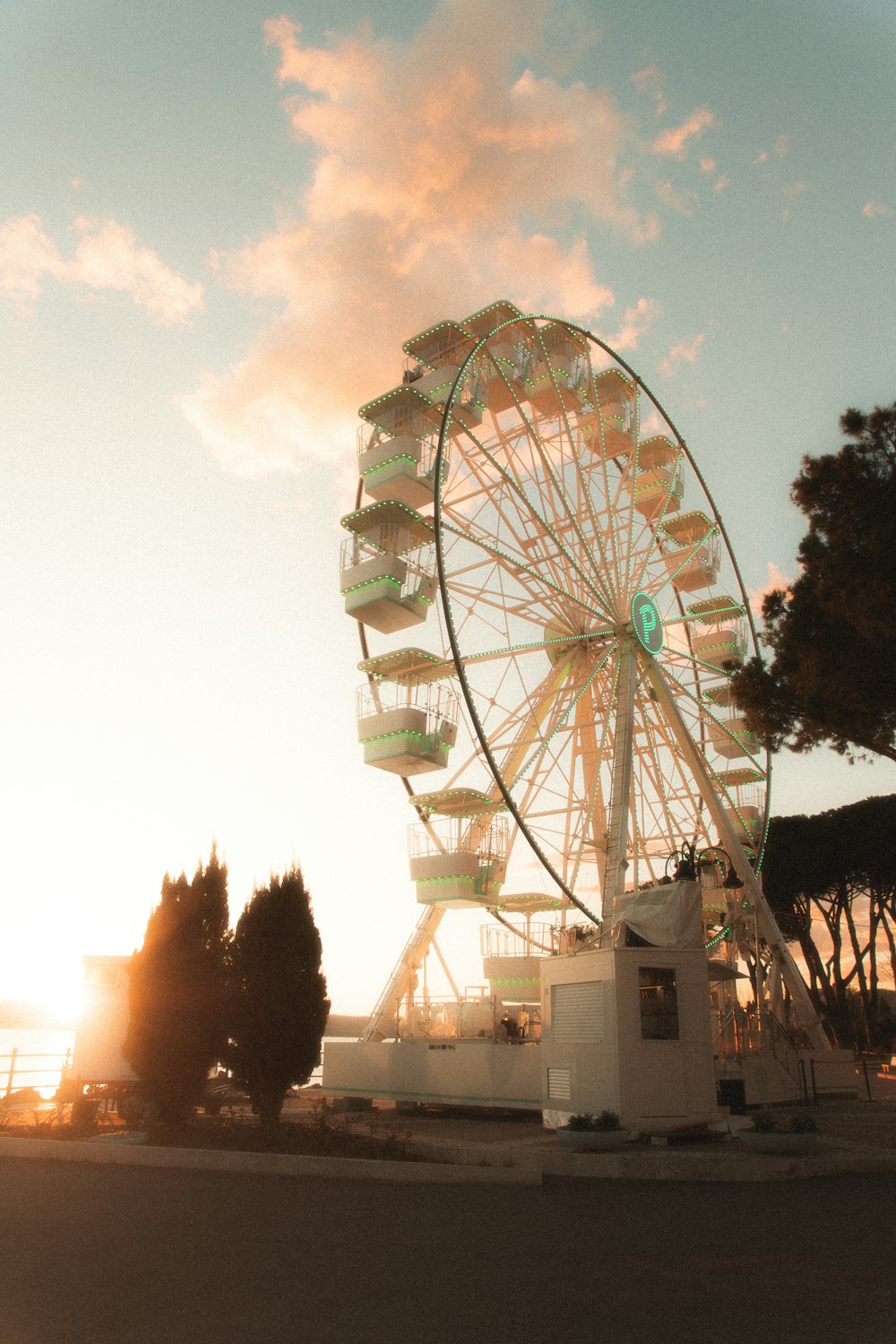 a ferris wheel sitting on top of a parking lot