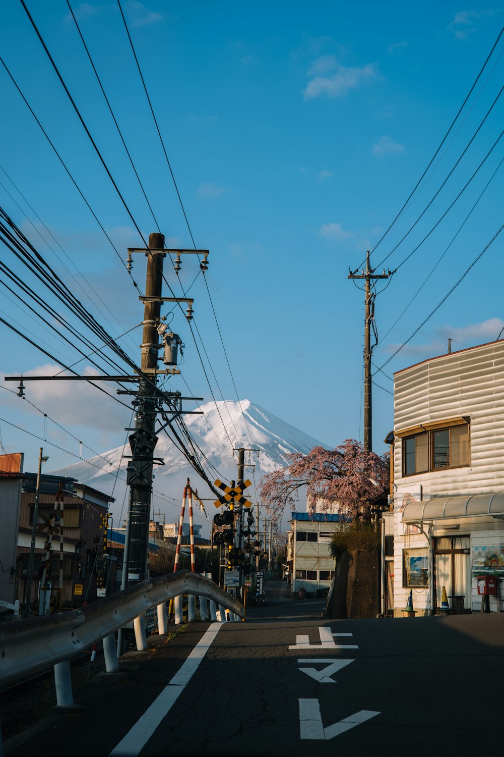 a street with power lines and a mountain in the background