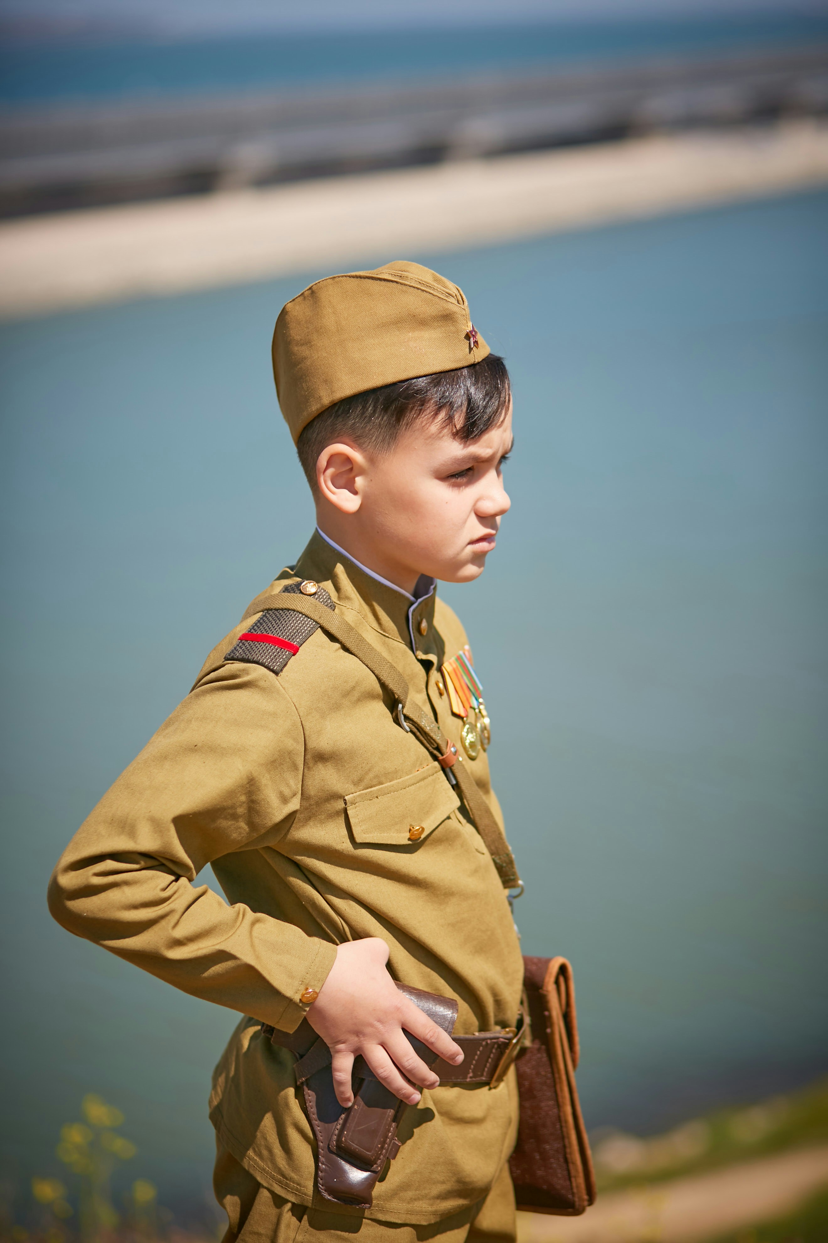 a young boy dressed in a military uniform