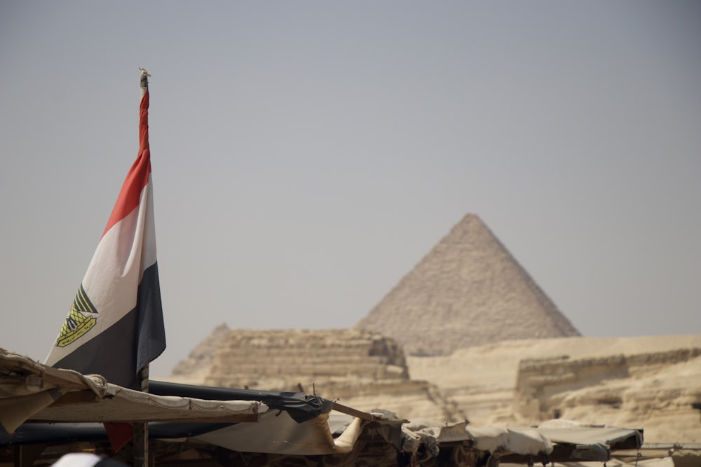 an egyptian flag flying in front of the pyramids of giza