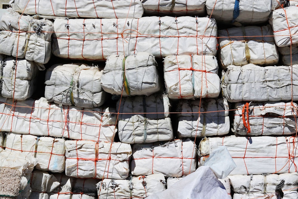 a pile of bags of cement sitting next to each other