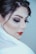 A close-up portrait of a person with makeup featuring bold red lipstick, dark eyeshadow, and long lashes, hair styled elegantly, and partially draped in a translucent white fabric.