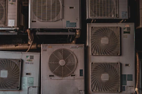 a bunch of air conditioners stacked on top of each other