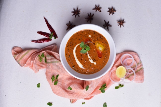 A steaming pot of curry simmering with rich, fragrant spices in a cozy home kitchen.