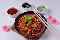 Elegant plating of stir-fried vegetables with glossy sauce and sesame seeds.