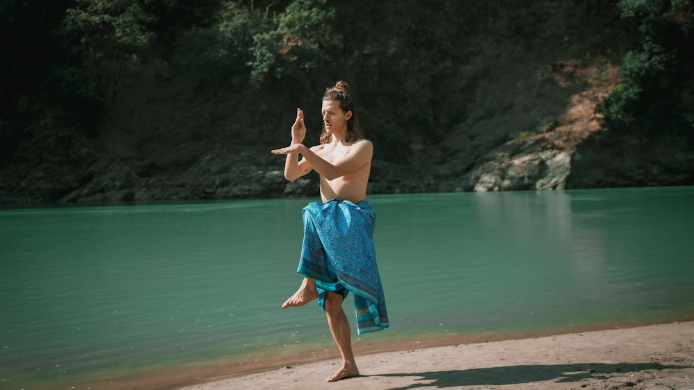 a person standing on a beach near a body of water