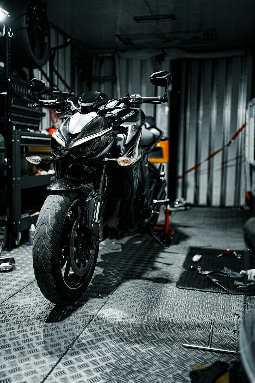 a black and white photo of a motorcycle in a garage