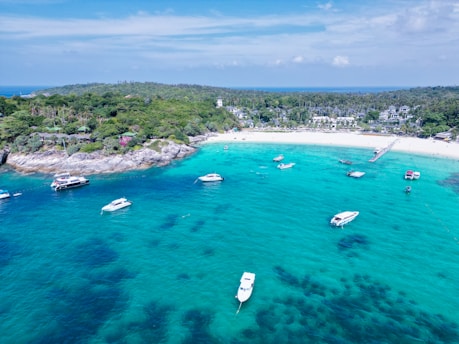 a group of boats floating on top of a body of water