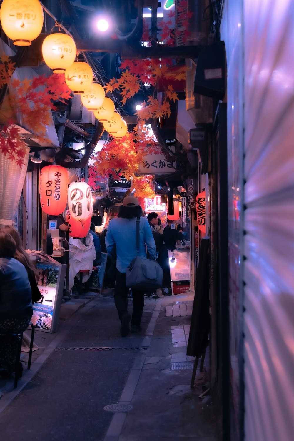 a group of people walking down a narrow street