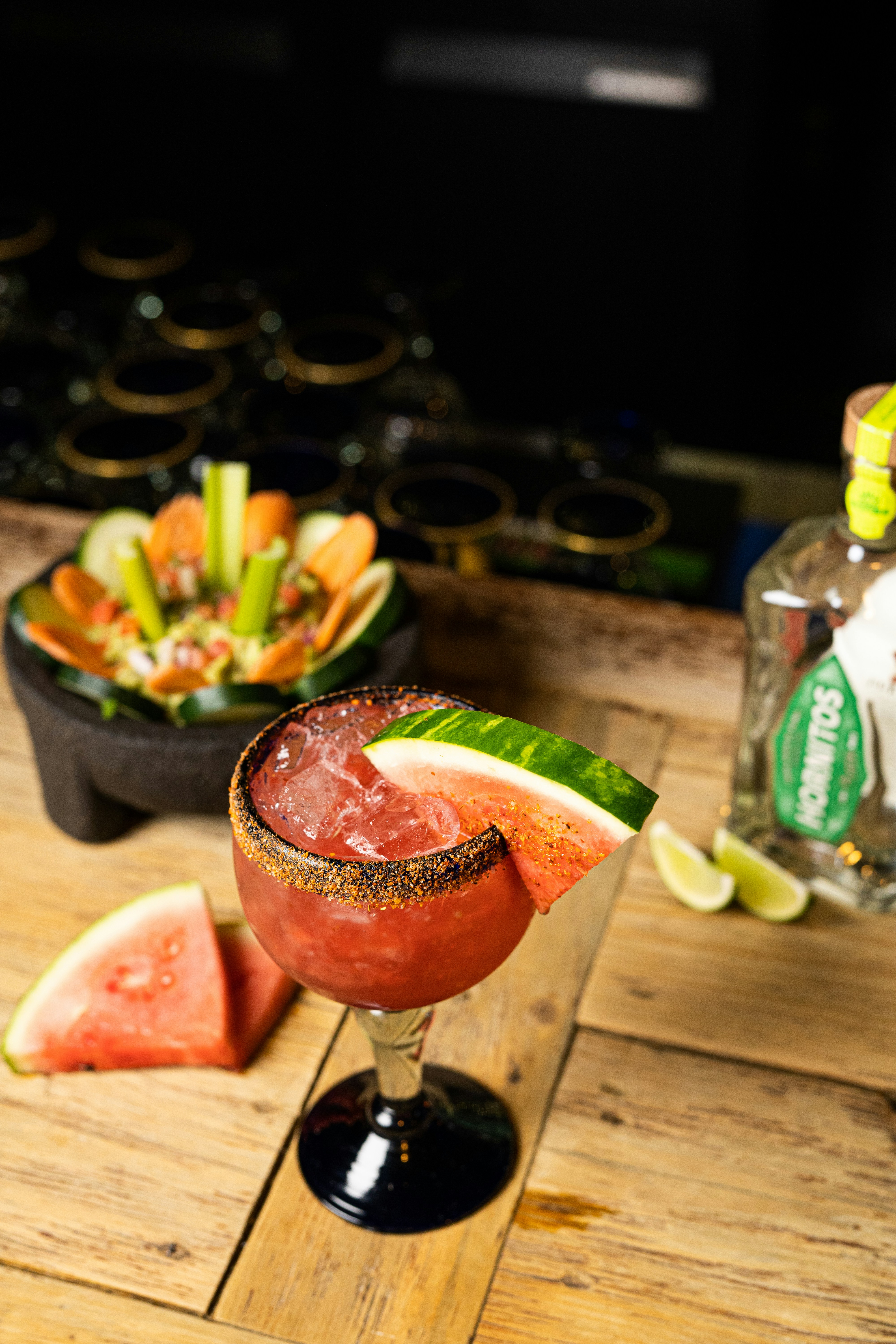 a drink with a slice of watermelon on the side