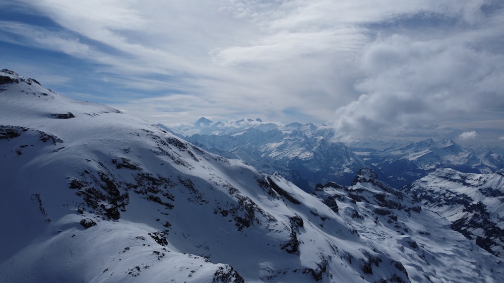 a view of a snowy mountain range from a plane