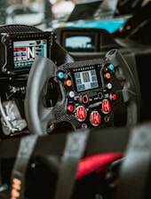 A close-up of a racing wheel and dashboard.