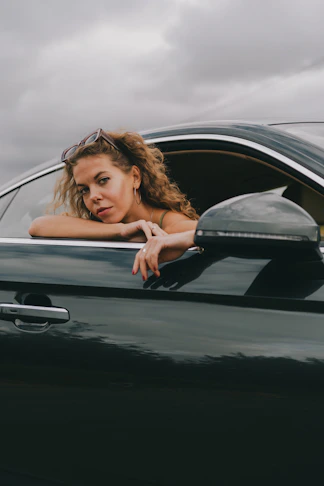 a woman leaning out of a car window