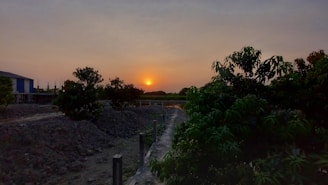 Sunset over a flat, cleared lot ready for construction with a dirt road.
