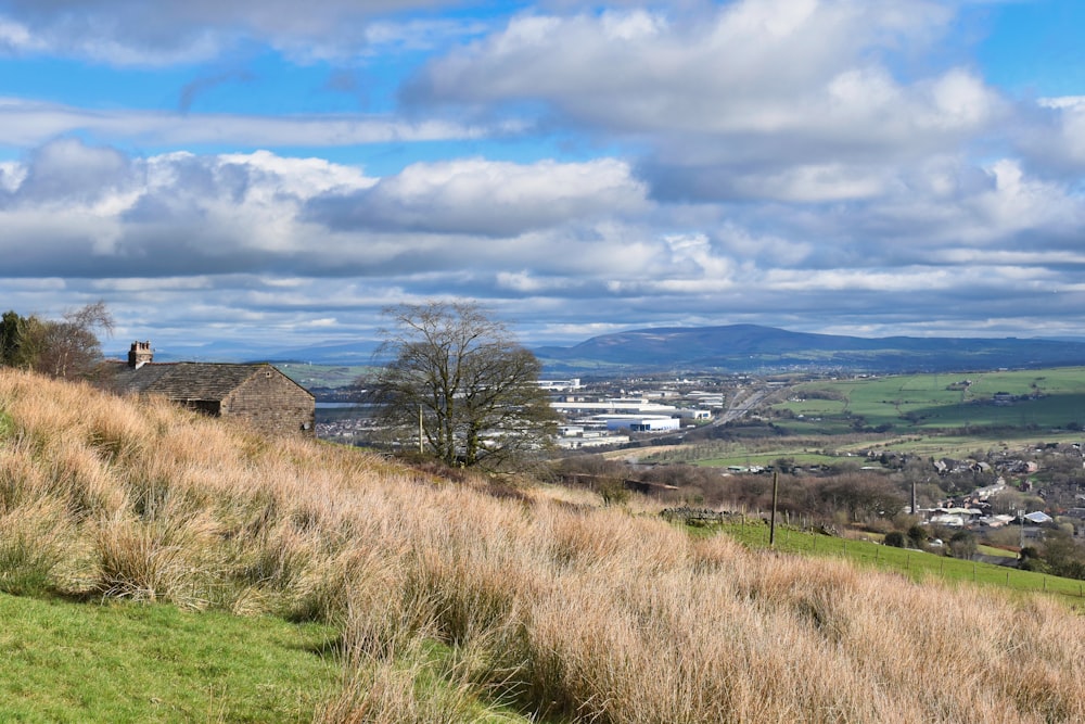 a grassy hill with a house on top of it