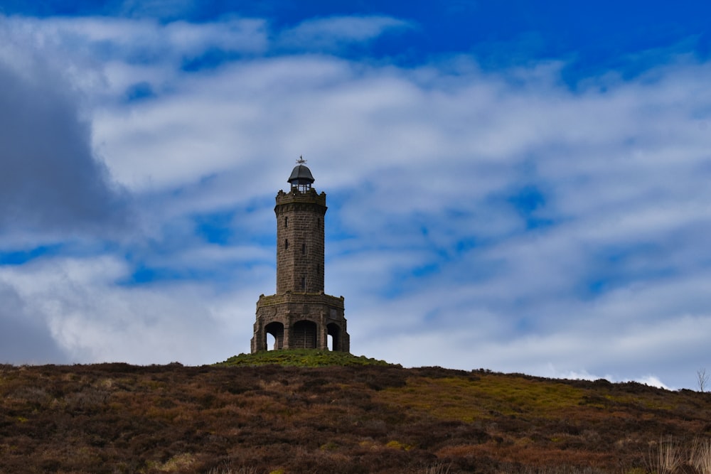 a tower on top of a hill with a sky background