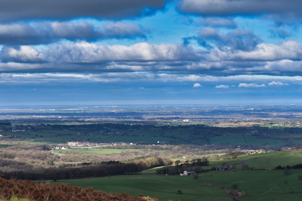 a view of the countryside from the top of a hill