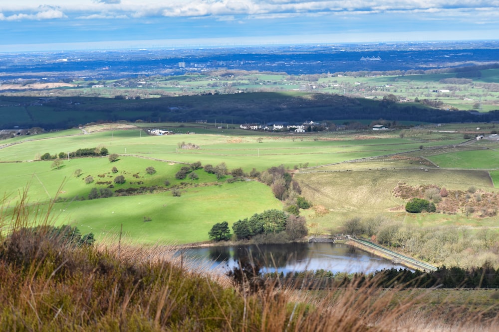 a view of a valley with a lake in the middle of it