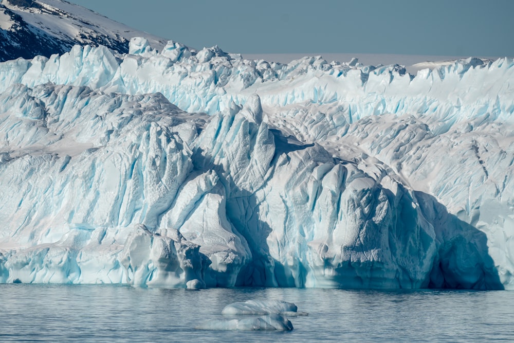 a large iceberg in the middle of a body of water