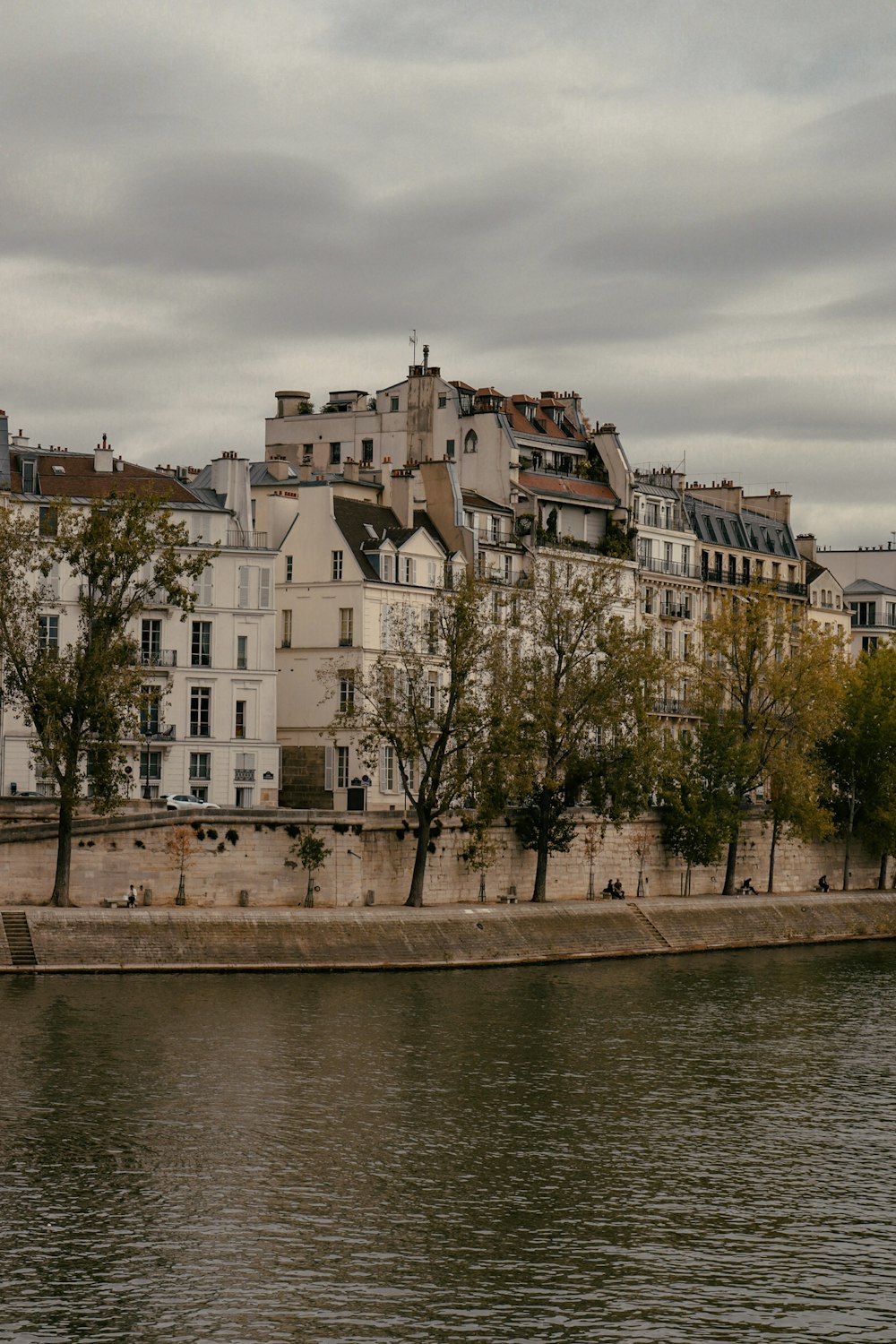 a body of water next to a row of buildings