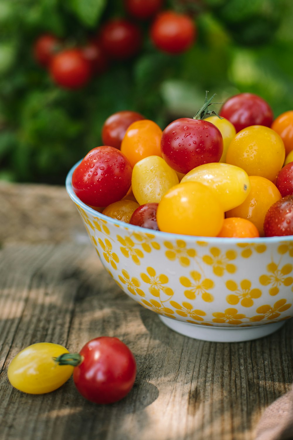 a bowl of fruit sitting on a wooden table