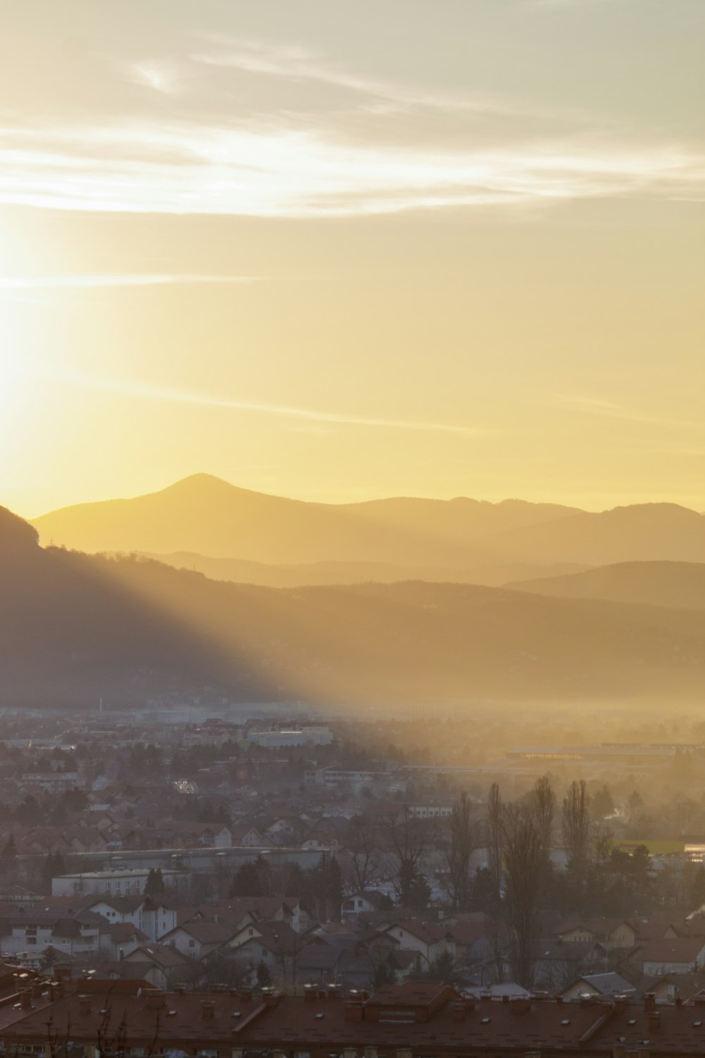 a view of a city with mountains in the background