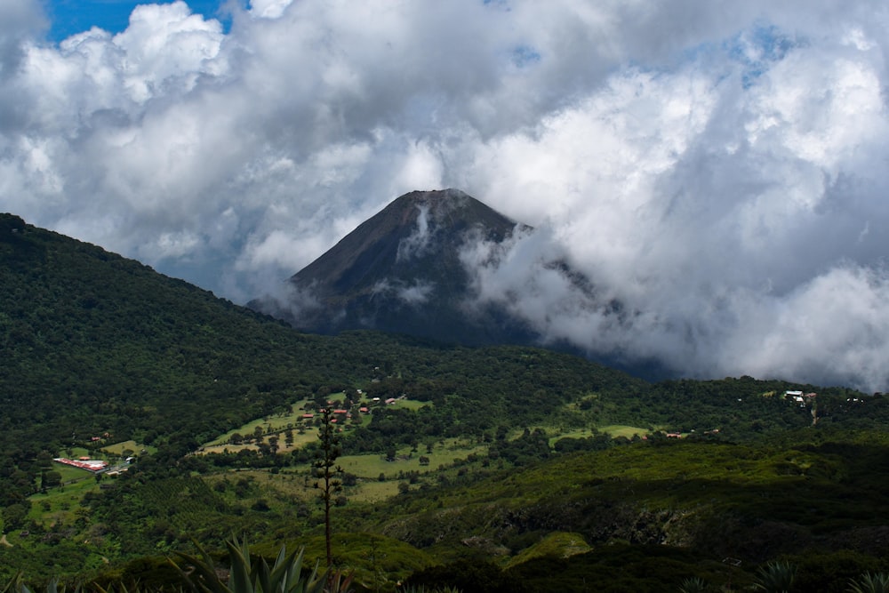 a view of a mountain covered in clouds