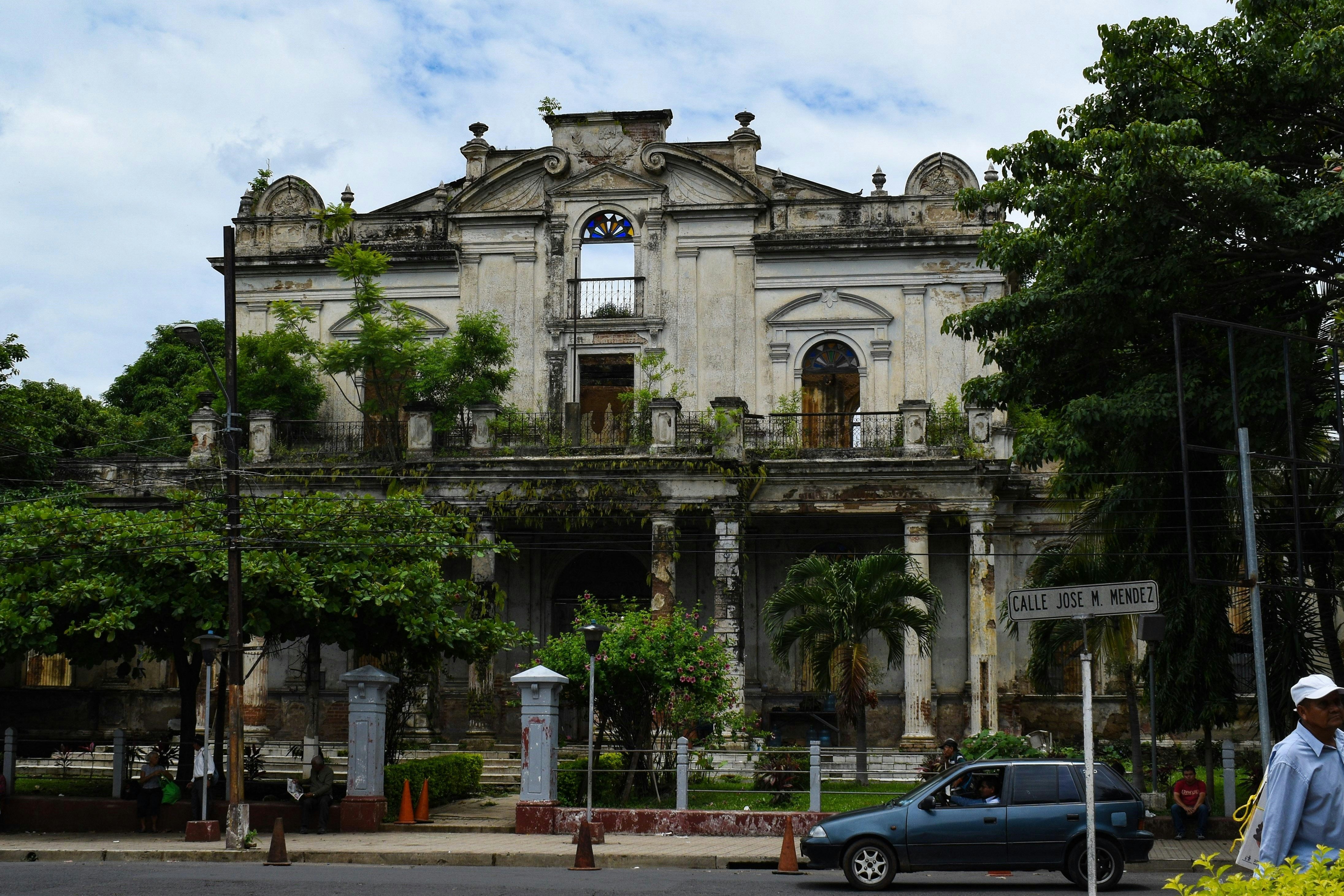 a car parked in front of an old building, 