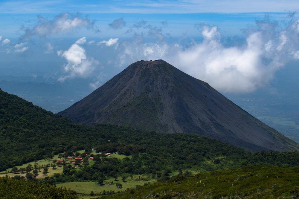 a view of a mountain with clouds in the sky