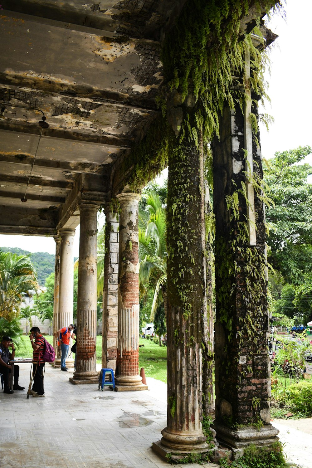 a group of people sitting under a covered walkway