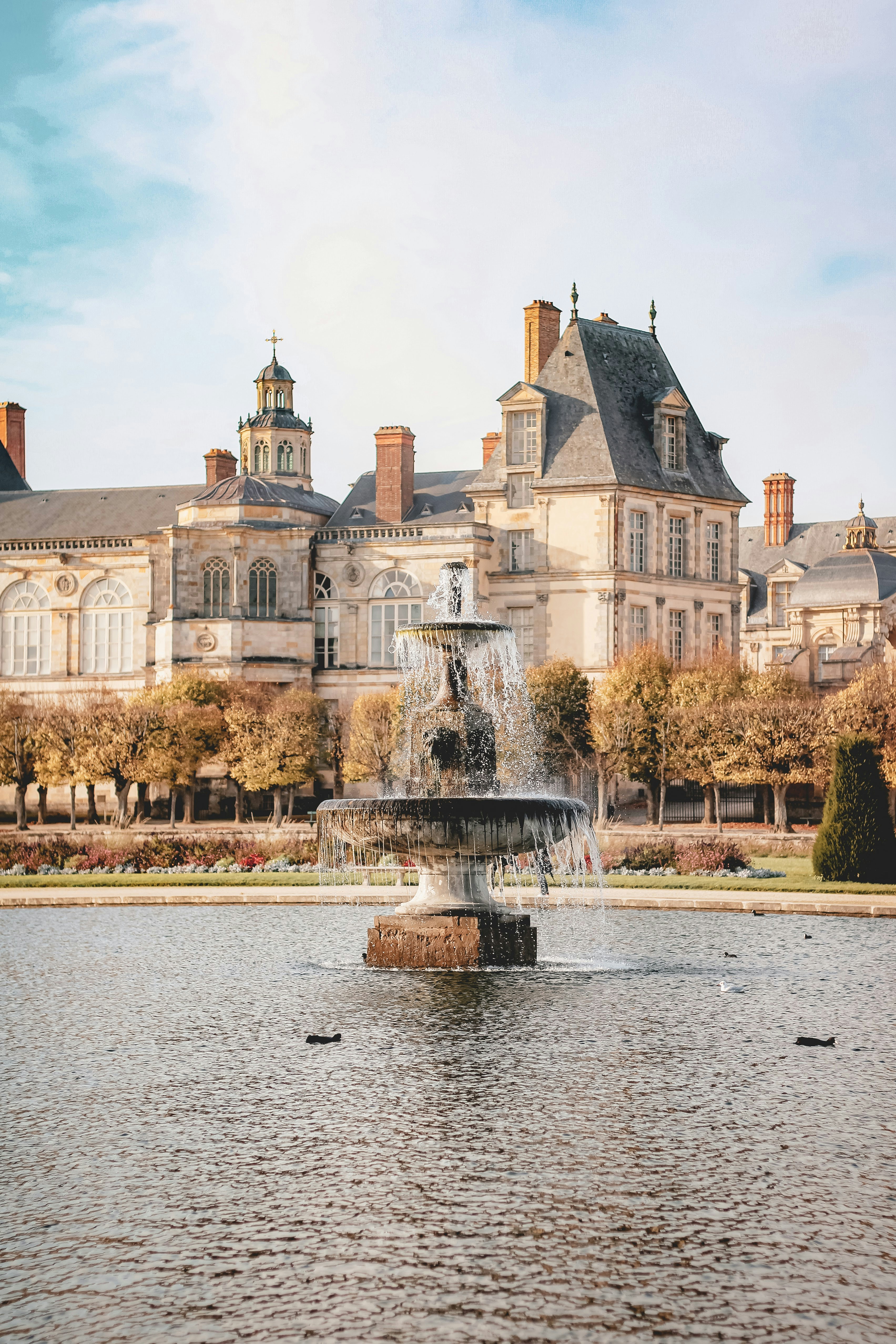 a large building with a fountain in front of it