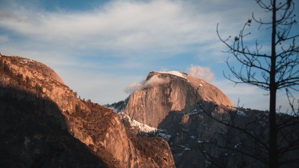 a view of a mountain with a cloud in the sky