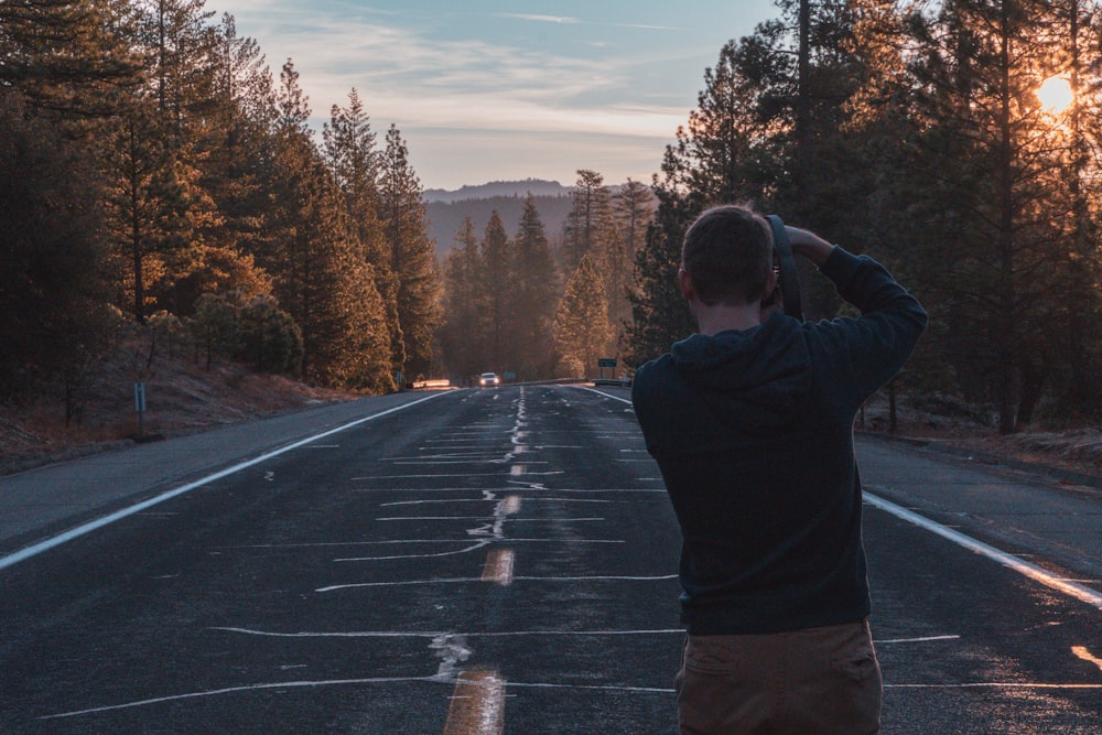 a man standing in the middle of a road