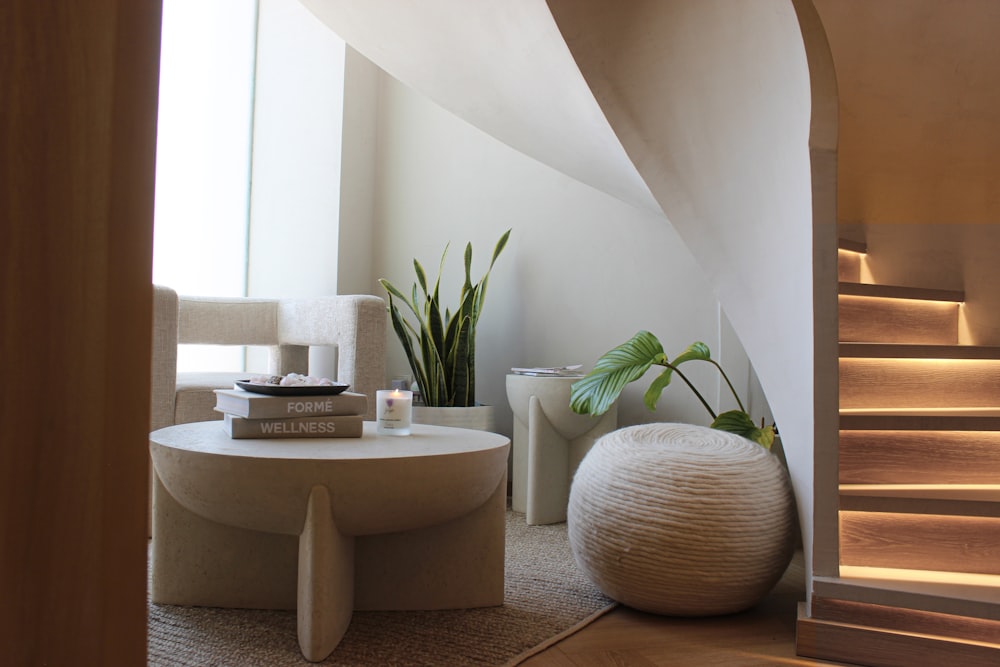 a living room with a staircase and a table