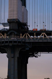 A close-up of hands building a bridge, representing infrastructure development.