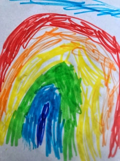 A colorful rainbow drawing in a childlike, sketchy style with arcs in red, orange, yellow, green, blue, and purple. Background shows a few scattered light blue lines.